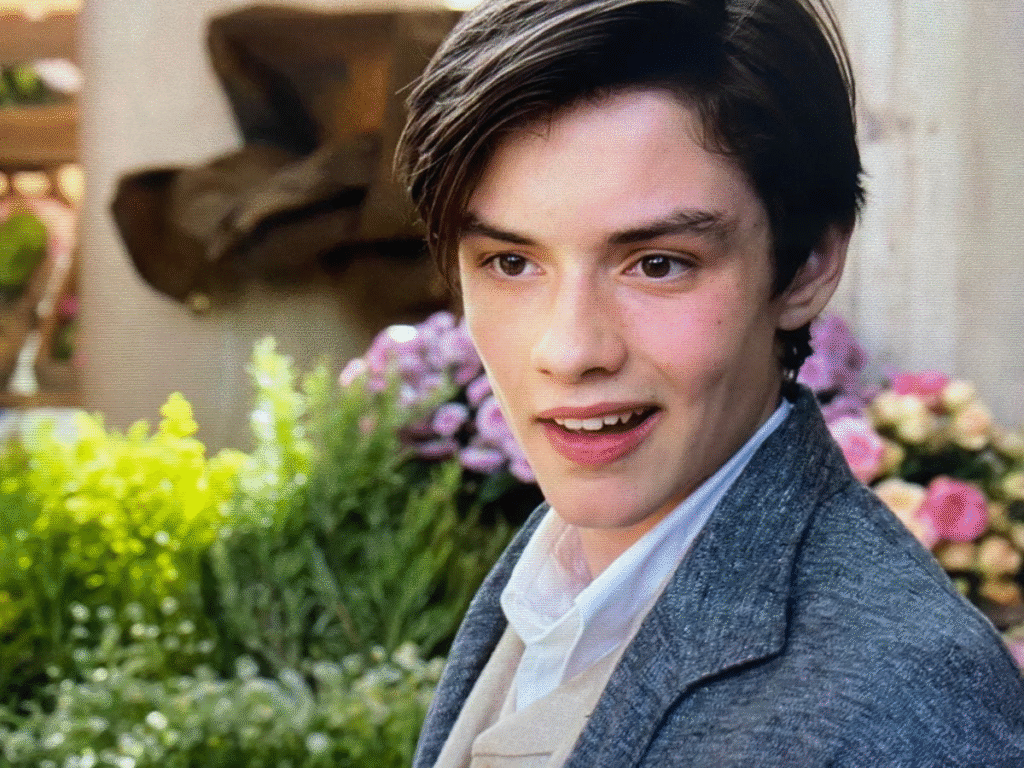 alt="Louis Partridge age during Enola Holmes premiere with Millie Bobby Brown"

