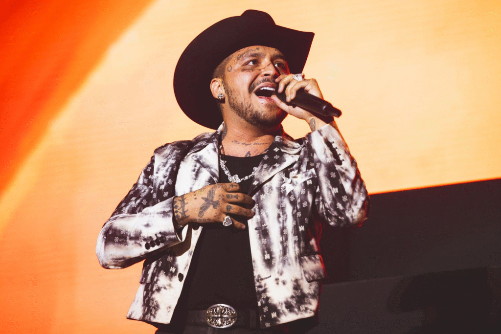 alt="Christian Nodal performing live - net worth growth through tours"