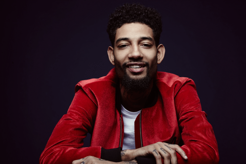alt="PNB Rock net worth lifestyle on stage performance"