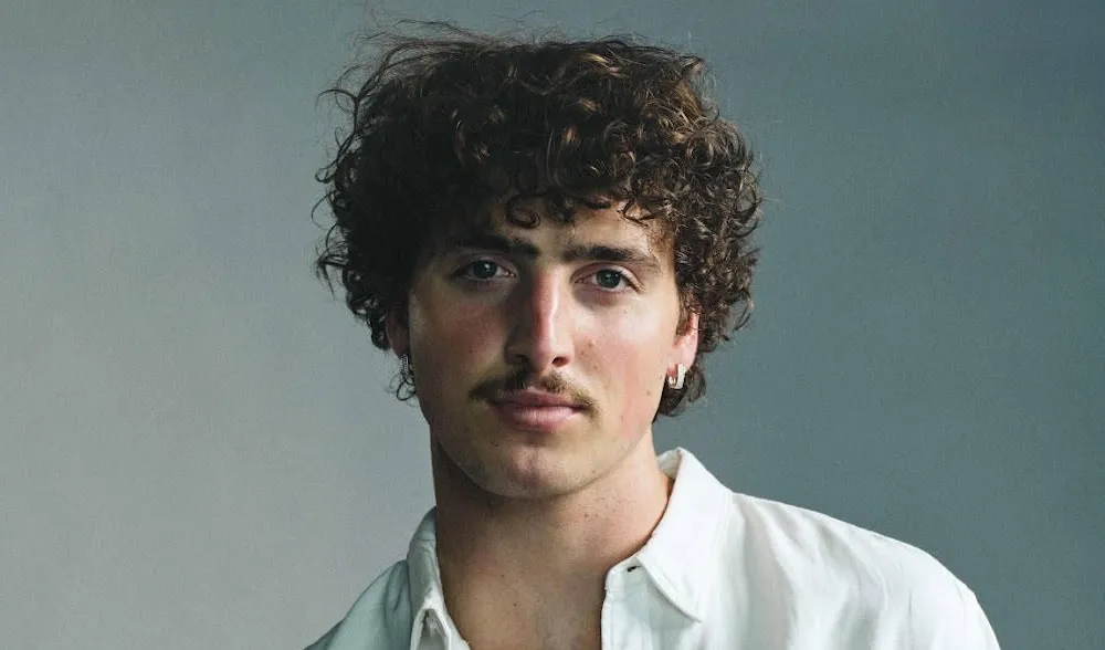 alt="Singer Benson Boone net worth growth through music and tours"