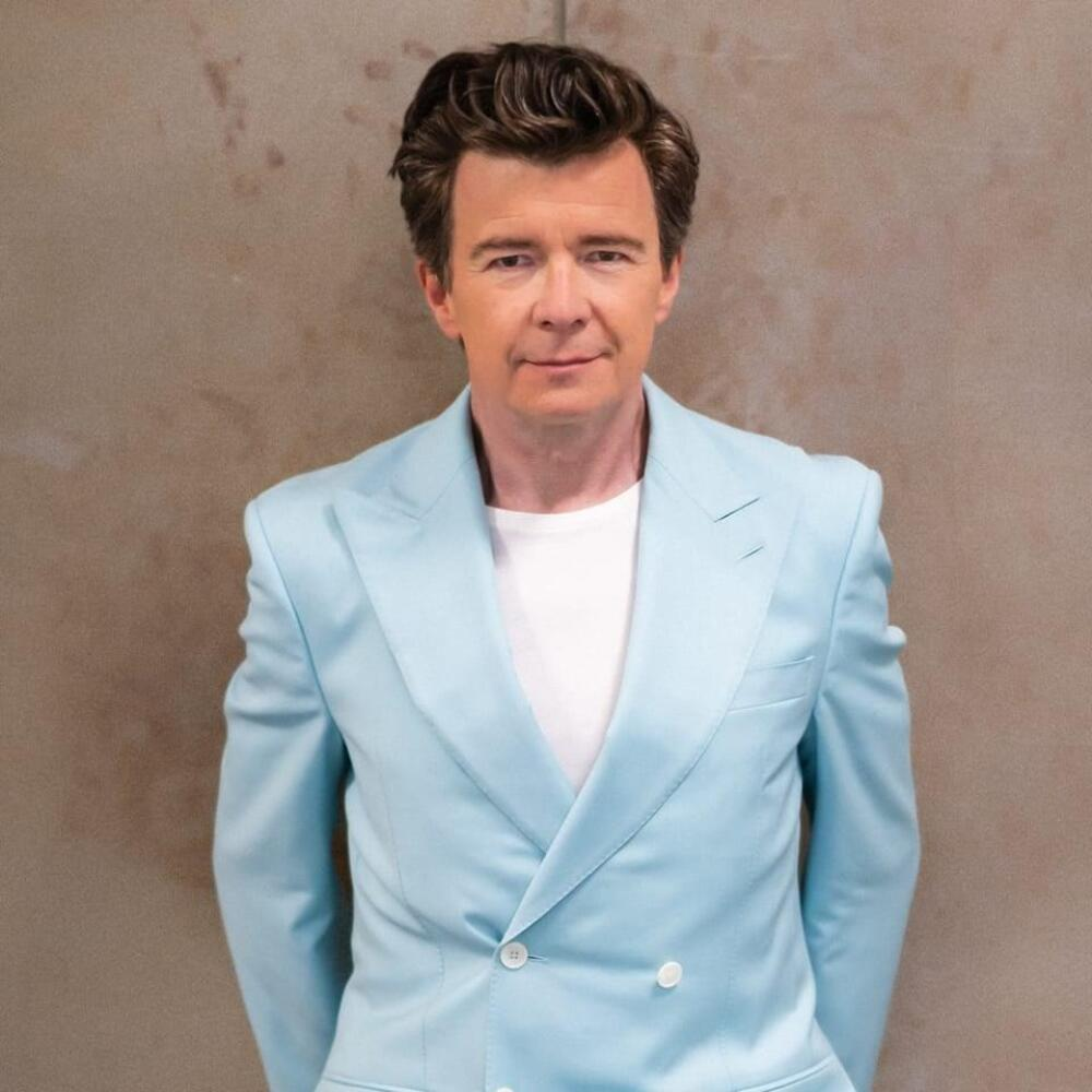 Rick Astley net worth 2025 performing live on stage