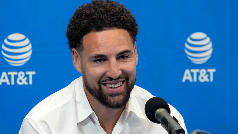 Klay Thompson shooting basketball during NBA game for net worth article