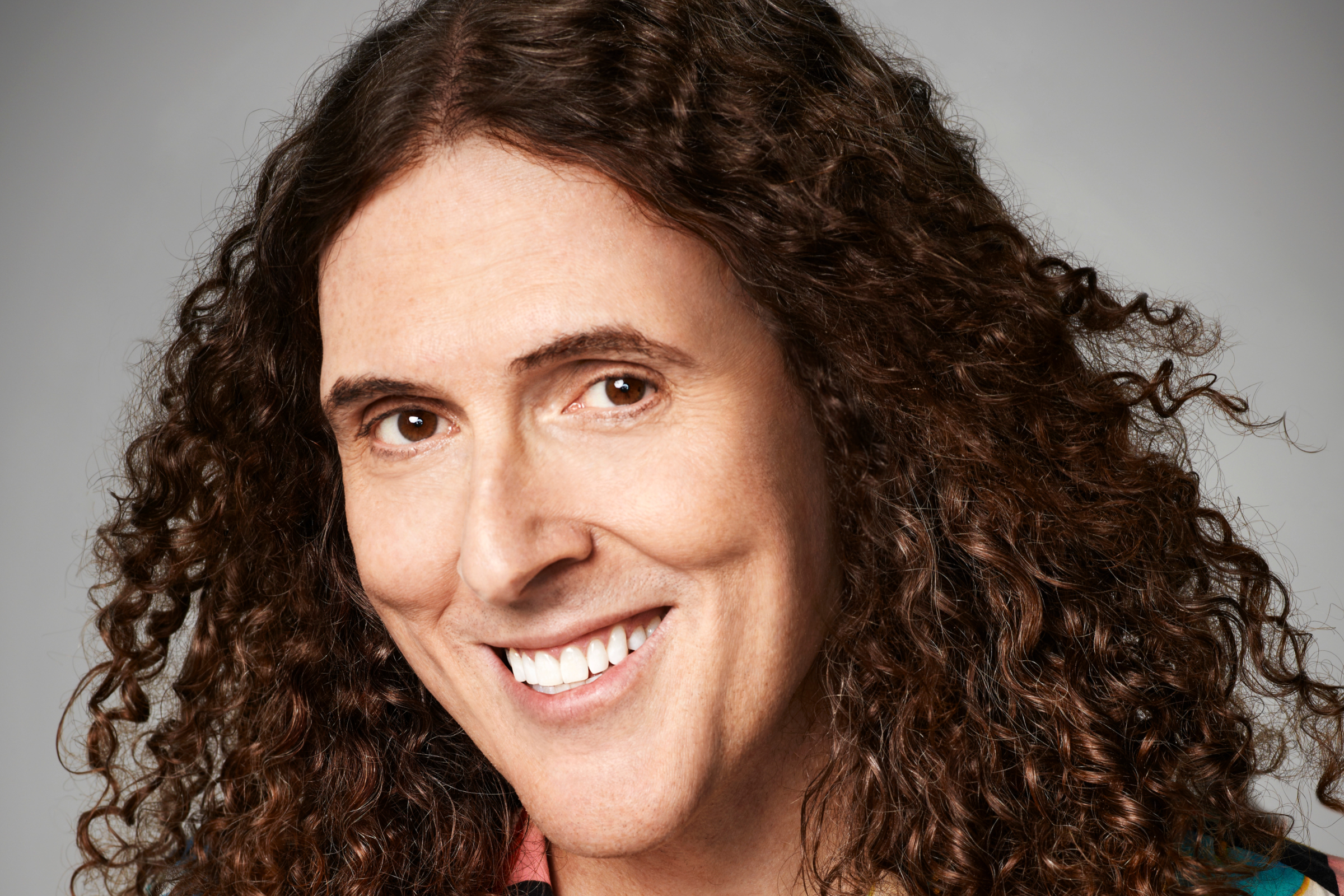 Weird Al Yankovic performing parody music on stage and building his net worth
